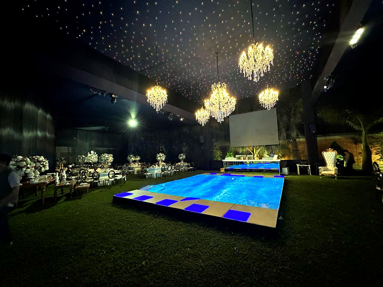 Pista de baile iluminada en azul bajo candelabros