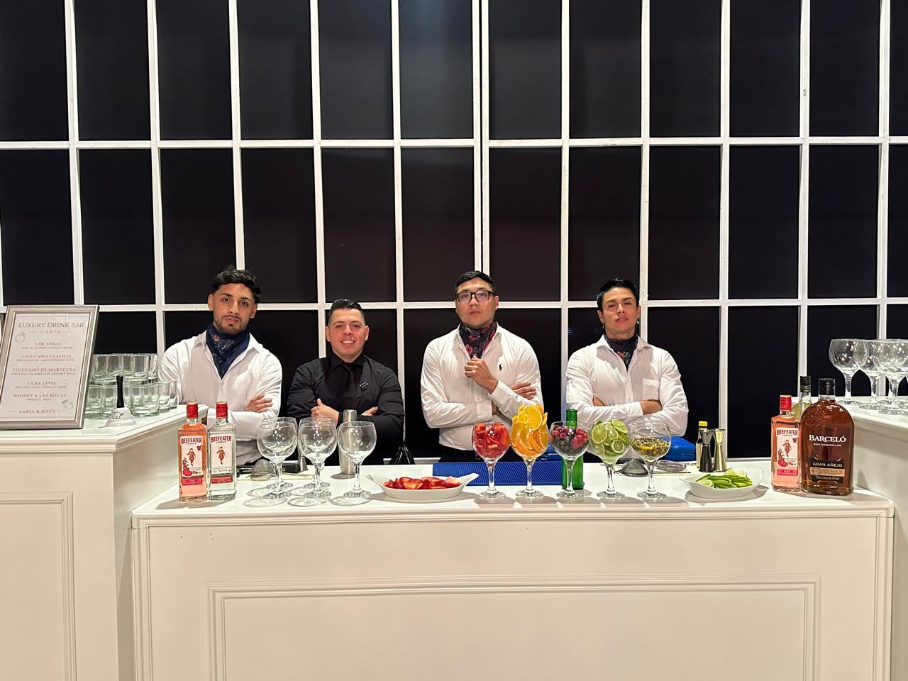 Barra de cócteles con bartenders uniformados
