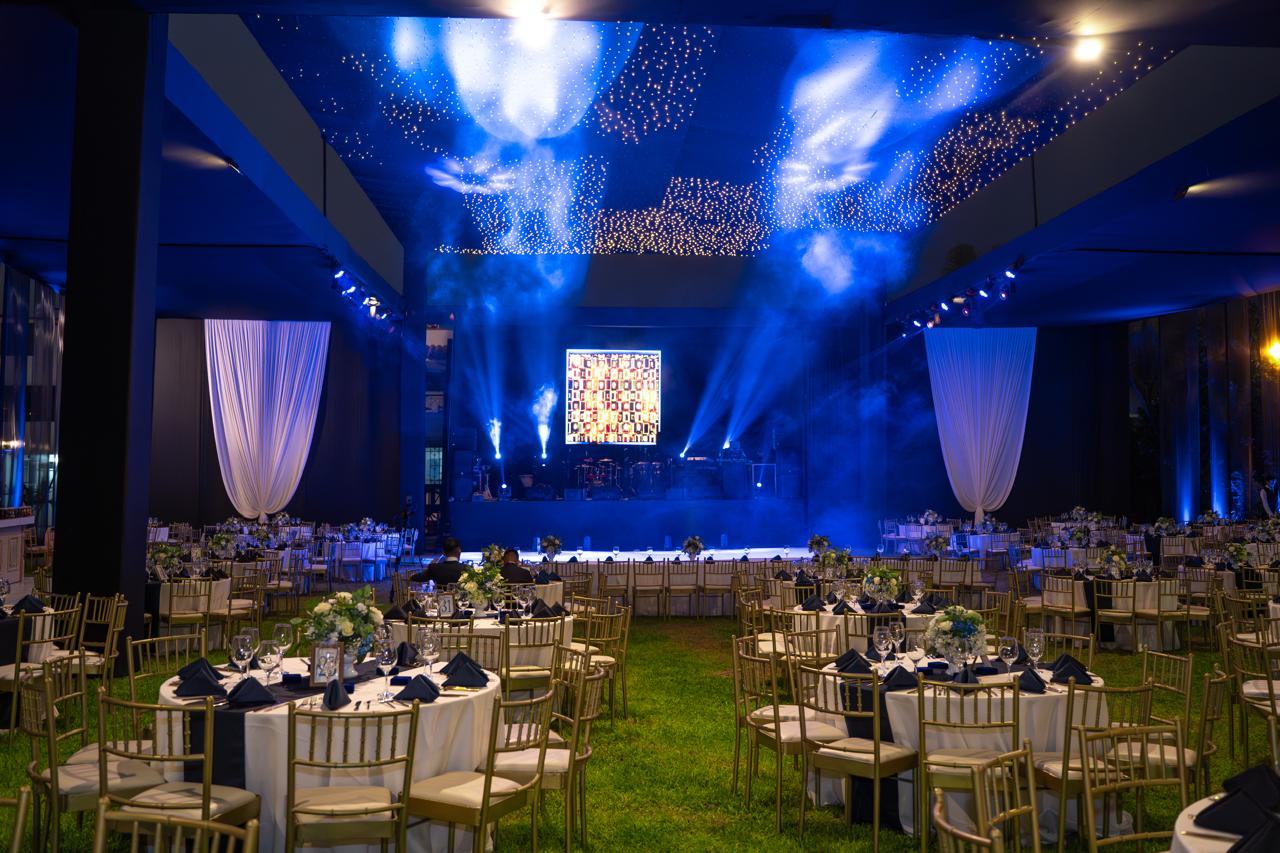 Salón de gala con mesas y luces azules