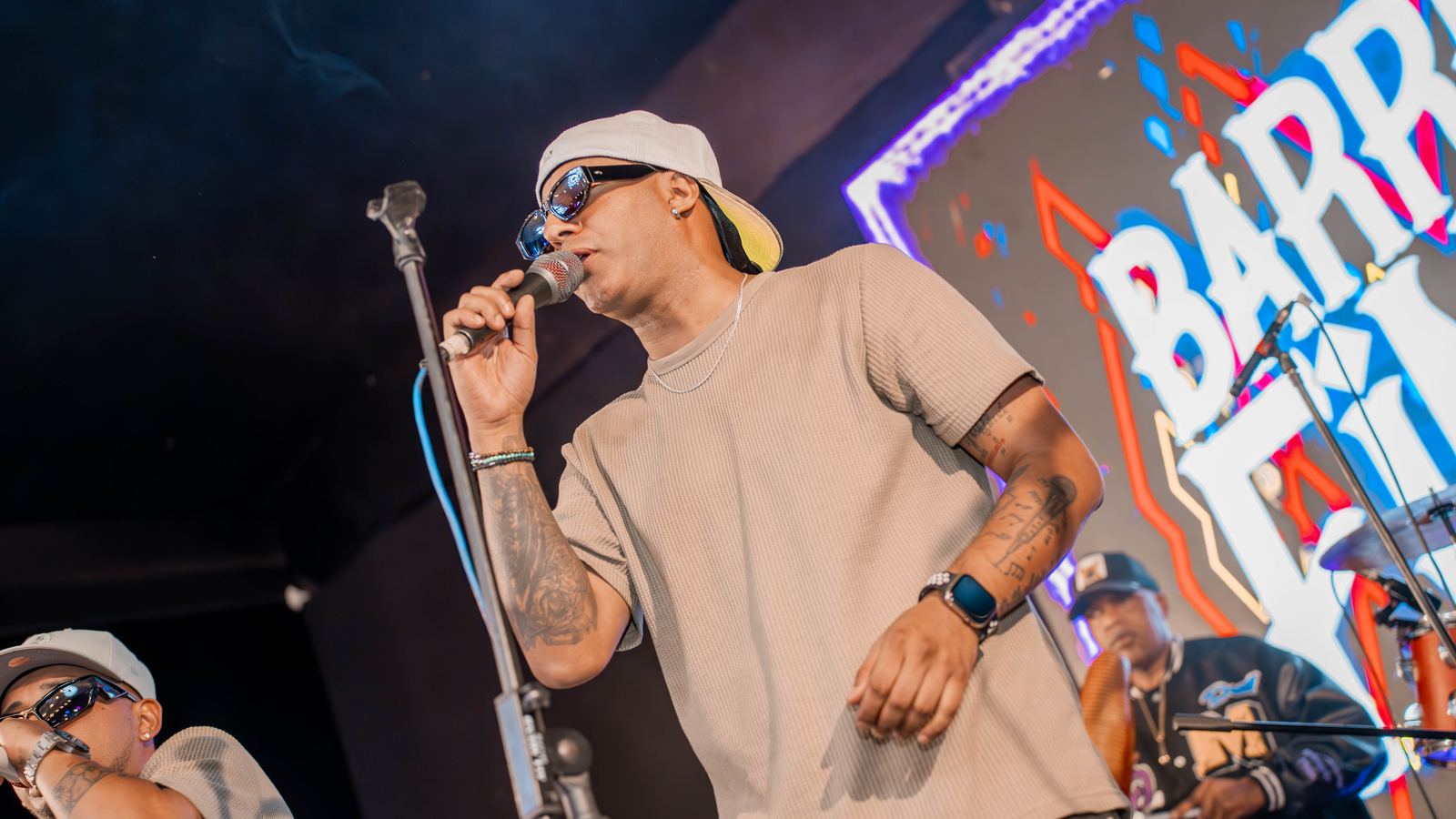 Cantante con gorro y lentes de sol en el escenario